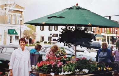 Vicki Stouffer stands next to one of the vendor spaces at the market in May 1999.