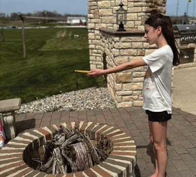 Lilian Barkholz, sixth grade student at HPI, uses a digital thermometer to collect air temperature data during the April 8 solar eclipse. The data was submitted to the NASA GLOBE program as part of a citizen science project.