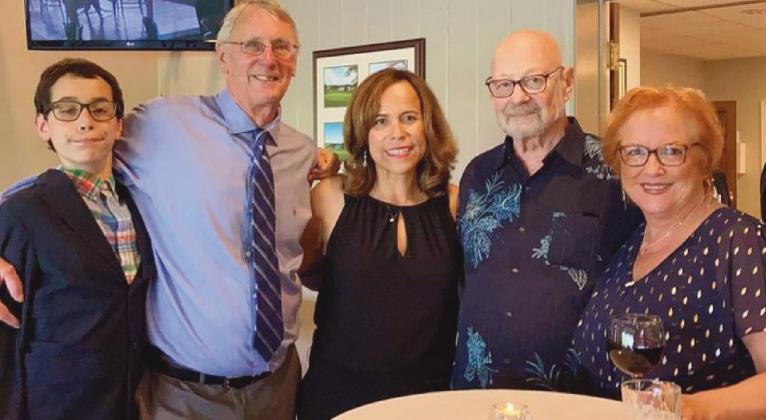 With Lorena Gloden, center, last July at the chapter meeting where she was named president of Rotary Club of Perrysburg, are, from left, her son Sebastian, her husband Dan, and her host parents Duane and Debbie Chappuies.